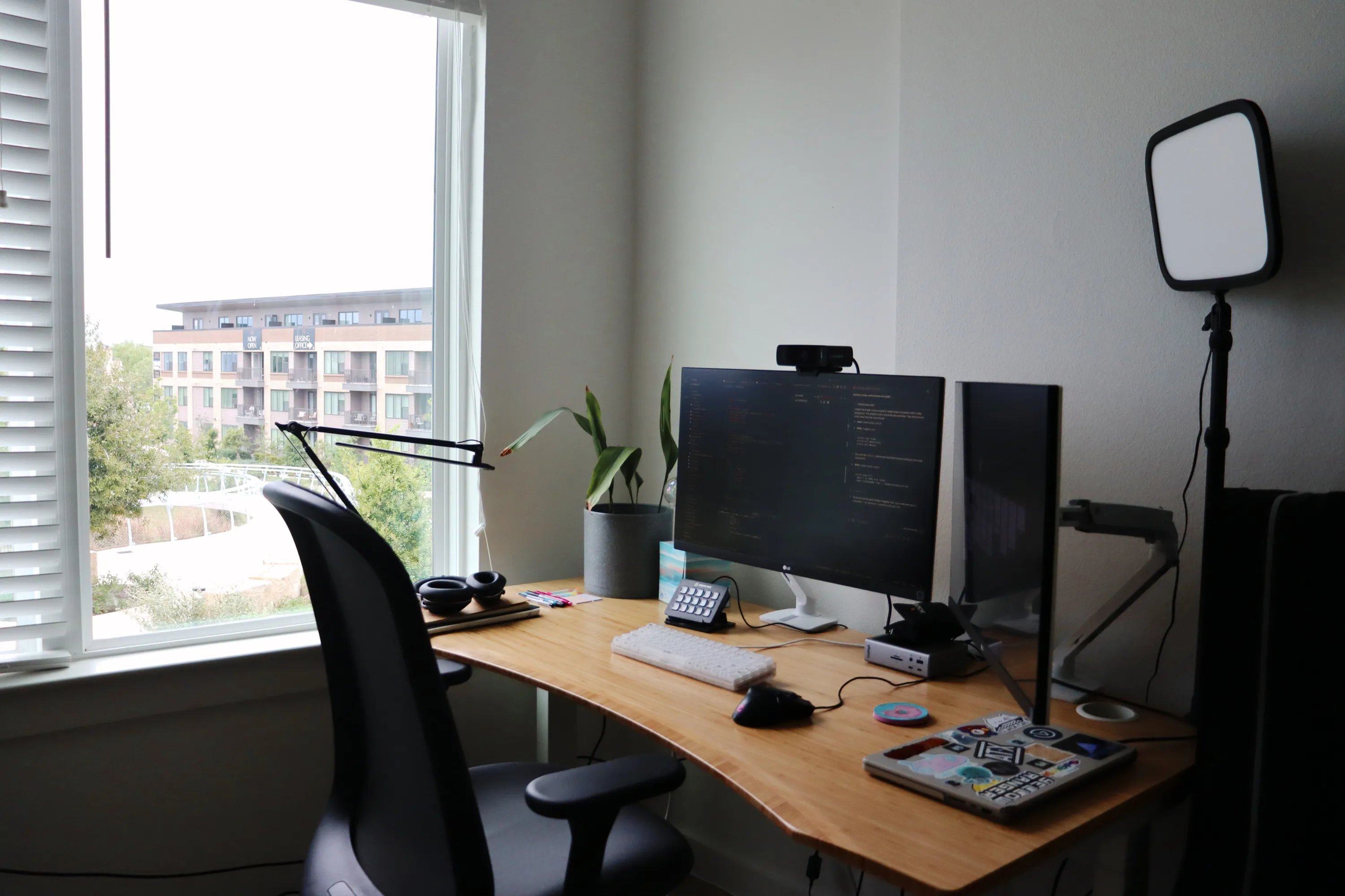 Big Ideas Studio home office with a desk, computer, a plant, and a view out the window